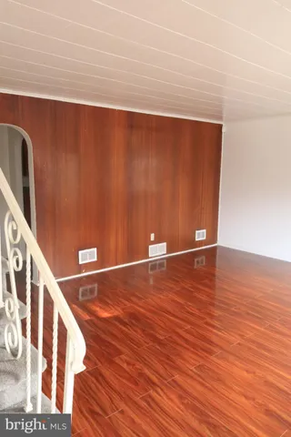 a view of an entryway with wooden floor and door