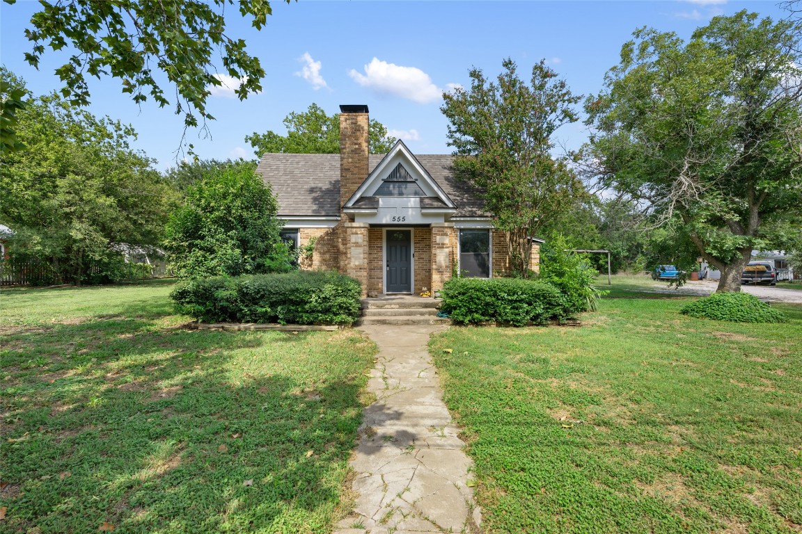 555 Hopewell Road Bertram, TX 78605 - Photo 4 of 21 View of front of home featuring a front lawn, a chimney, and brick siding