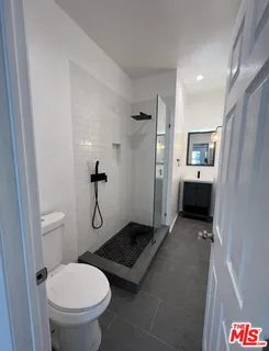 a bathroom with a toilet sink and shower