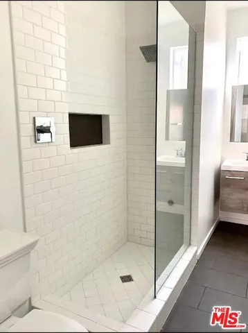 a bathroom with a shower and a sink