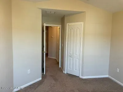 wooden floor and closet area in a room