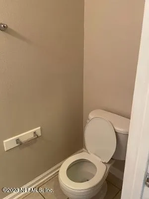 a white toilet sitting next to a sink