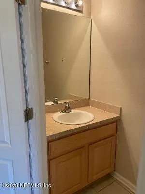 a bathroom with a sink and mirror