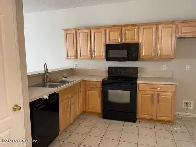a kitchen with a sink stove and microwave
