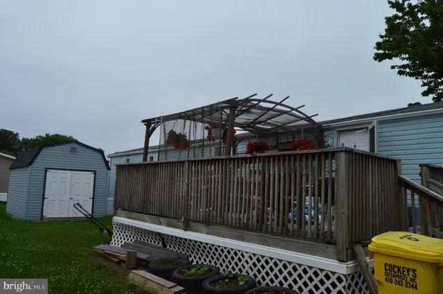 a view of a roof deck with wooden floor and fence