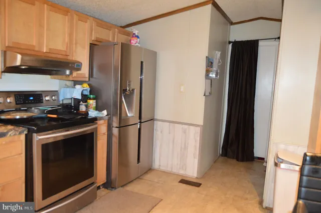 a kitchen with a refrigerator stove and cabinets
