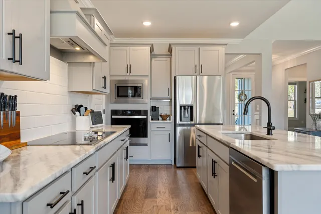 a kitchen with cabinets and chairs