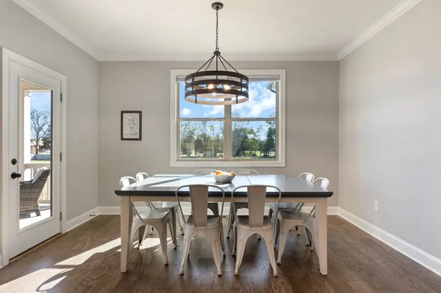 a view of a dining room with a table chairs and chandelier