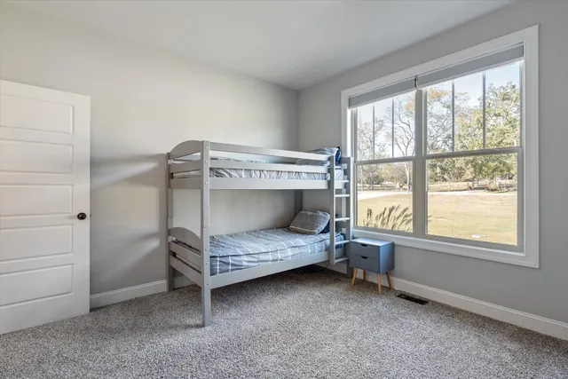 a bathroom with a granite countertop sink a toilet a mirror a bathtub and shower