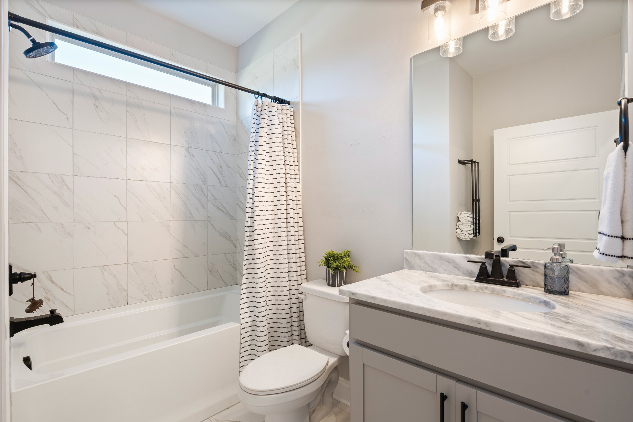 2070 Hamilton Chambers Road Lebanon, TN 37087 - Photo 23 of 43 a bathroom with a granite countertop sink a toilet a mirror a bathtub and shower