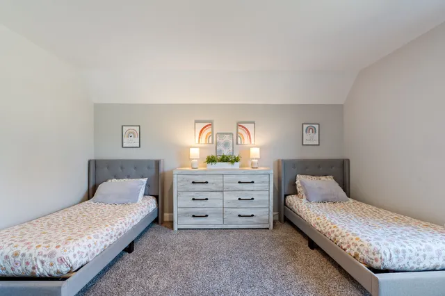 a spacious bedroom with a bed and a window