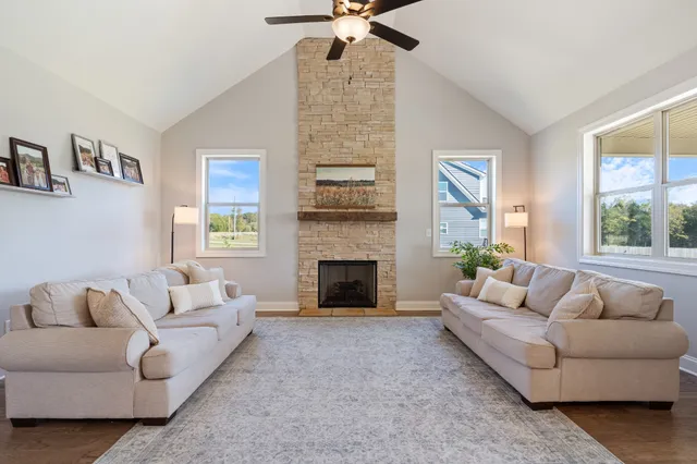 a living room with furniture and a fireplace