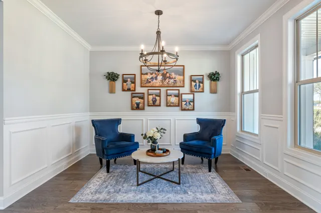a living room with furniture and a chandelier