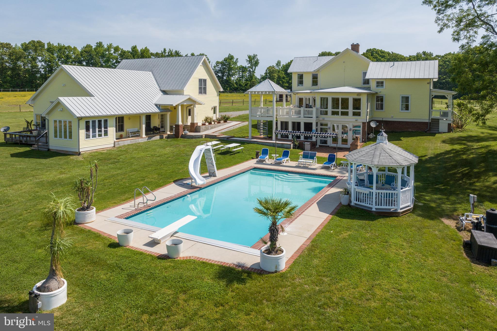 an aerial view of a house with swimming pool garden and patio