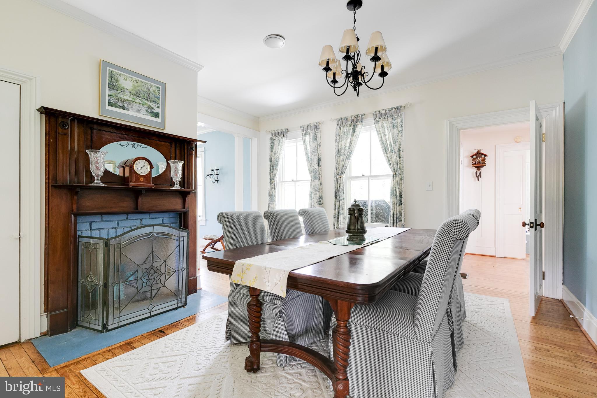2379 Pendleton Road Mineral, VA 23117 - Photo 16 of 55 a dining room with furniture a rug and a fireplace