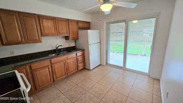 a kitchen with stainless steel appliances granite countertop a refrigerator sink and cabinets