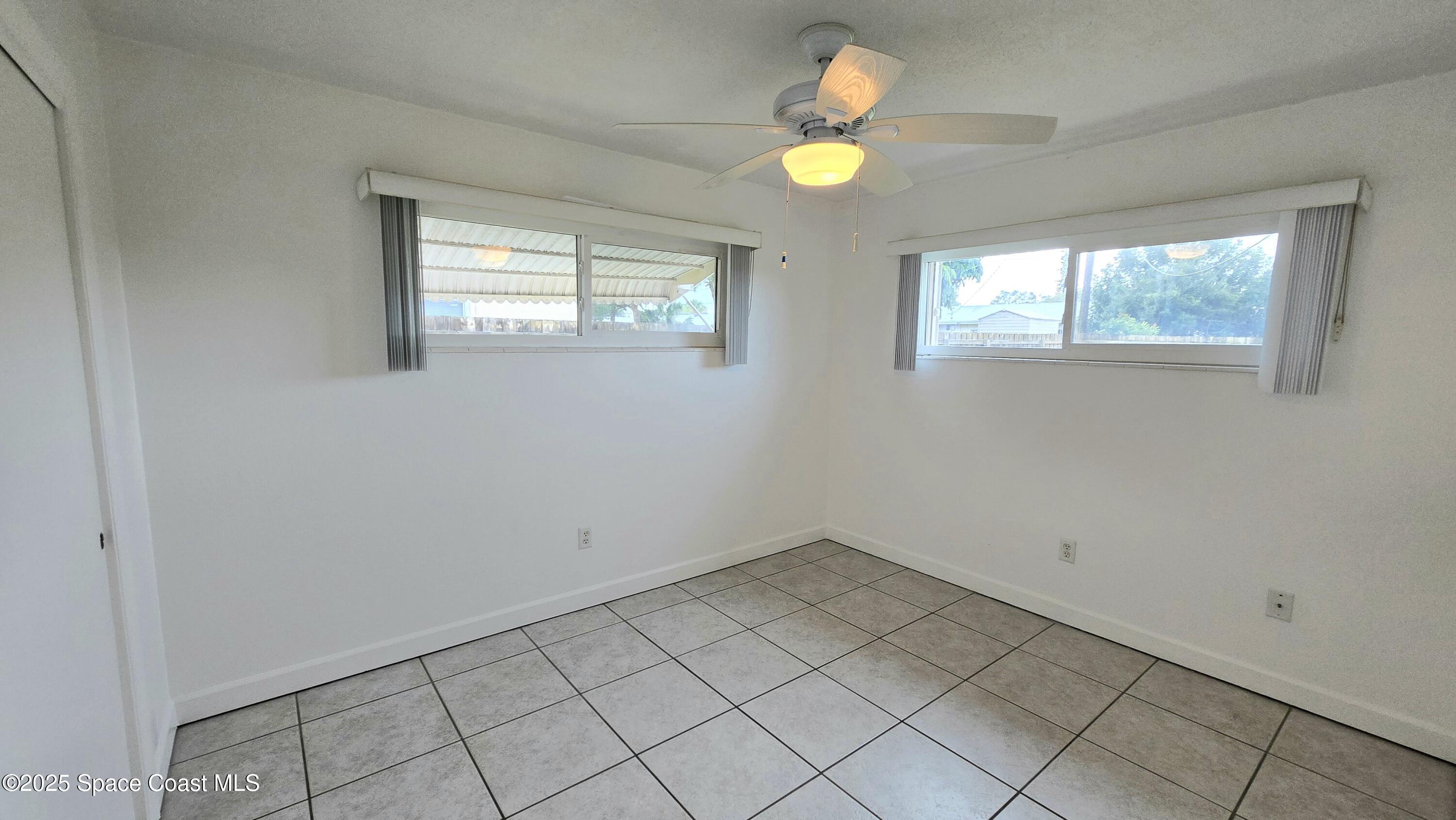 535 Lee Avenue, Unit A Satellite Beach, FL 32937 - Photo 6 of 12 an empty room with window