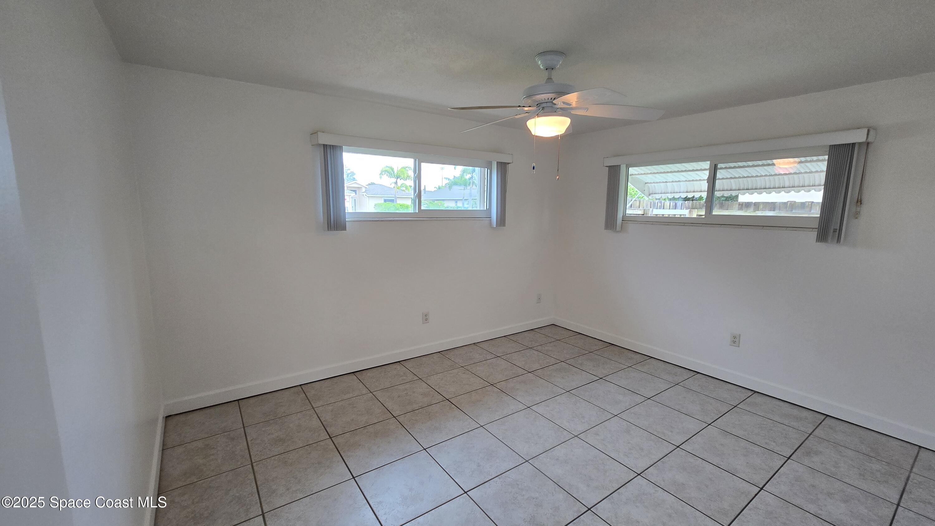 535 Lee Avenue, Unit A Satellite Beach, FL 32937 - Photo 7 of 12 a view of an empty room with window