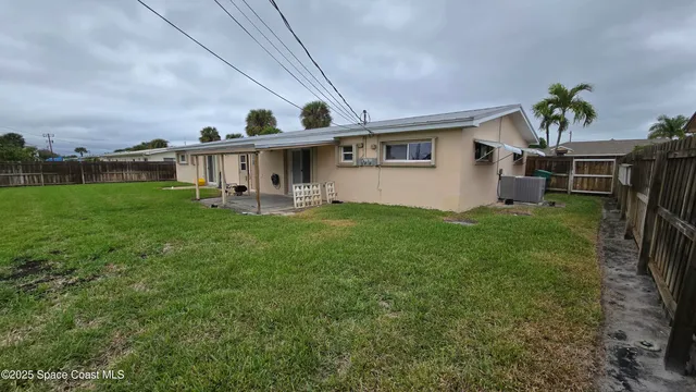 a view of a house with a yard and sitting area