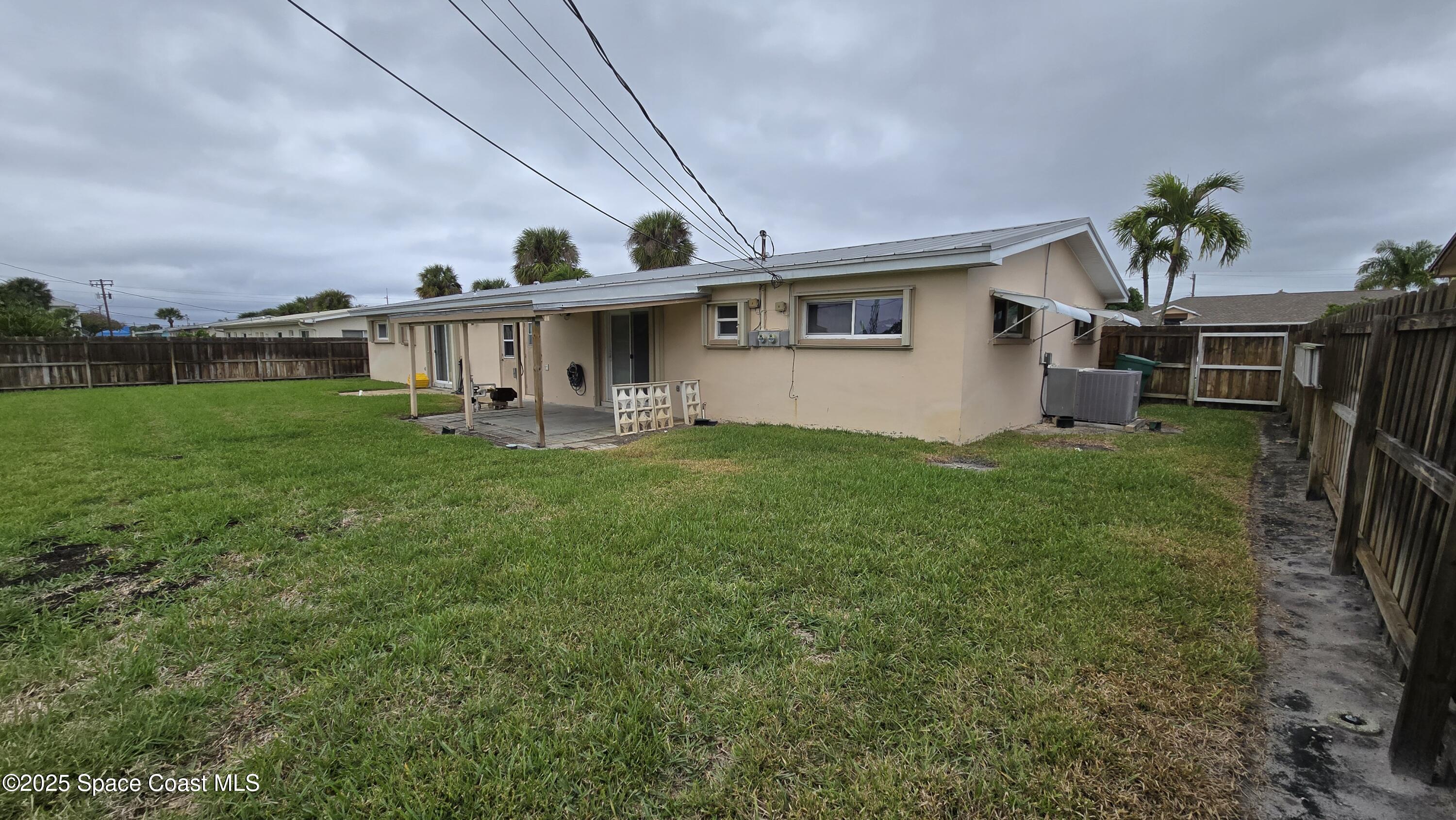 535 Lee Avenue, Unit A Satellite Beach, FL 32937 - Photo 10 of 12 a view of a house with a yard and sitting area