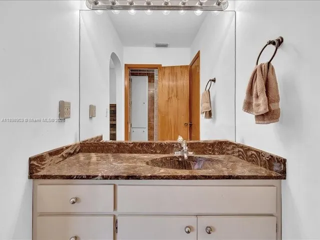 a view of kitchen with cabinets and refrigerator