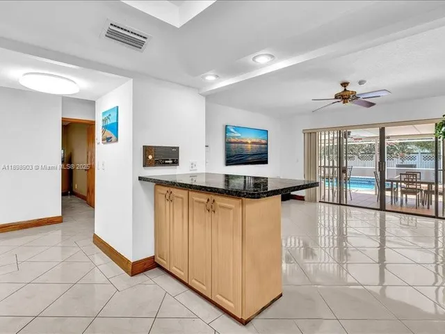 a kitchen with stainless steel appliances granite countertop a sink a stove a counter space and cabinets