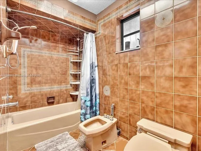 a kitchen with granite countertop a stove a sink and a microwave