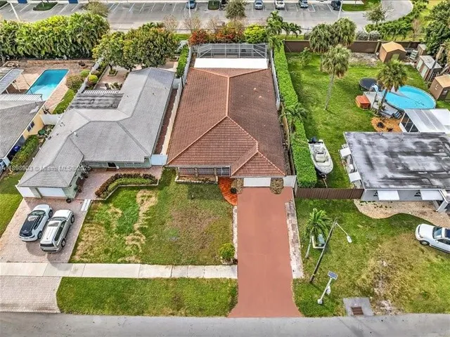 an aerial view of a house with a yard basket ball court and outdoor seating