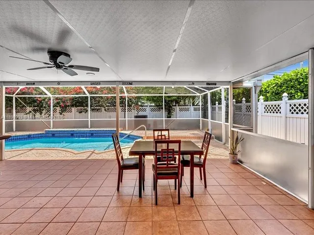 a dining hall with stainless steel appliances granite countertop a table and chairs