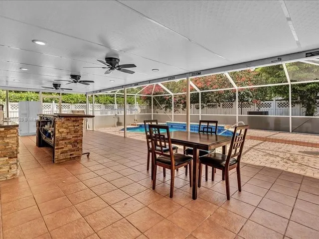 a view of a dining room with wooden floor and iron fence