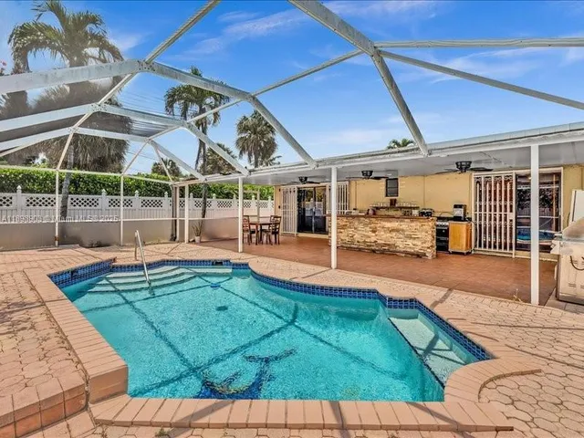 a large kitchen with counter top space appliances and cabinets