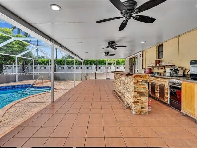 a kitchen with stainless steel appliances kitchen island granite countertop a stove a sink and a refrigerator