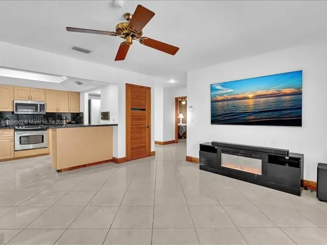 a bedroom with a bed and a ceiling fan
