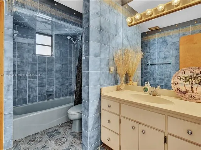 a bathroom with a toilet and bathtub