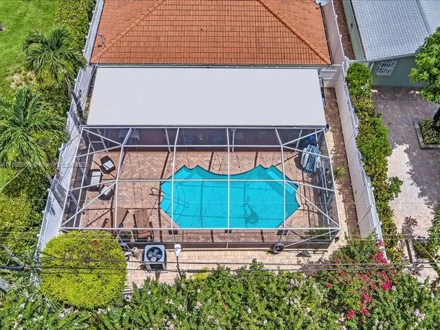 an aerial view of a house with a yard and a bench