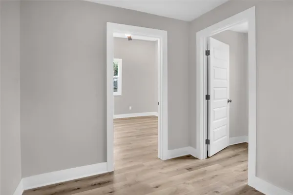 an empty room with wooden floor