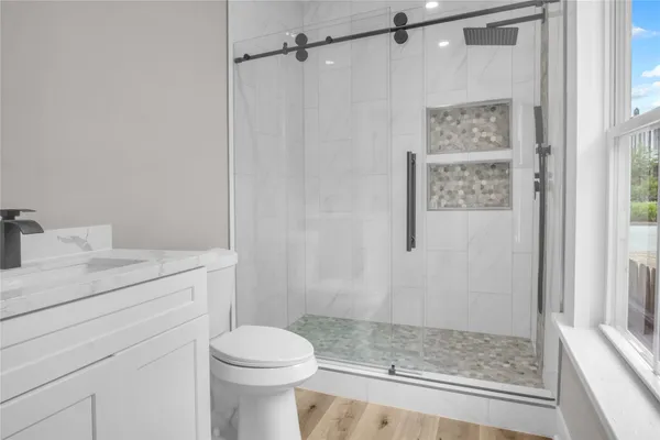 a view of a small space with wooden floor and a window