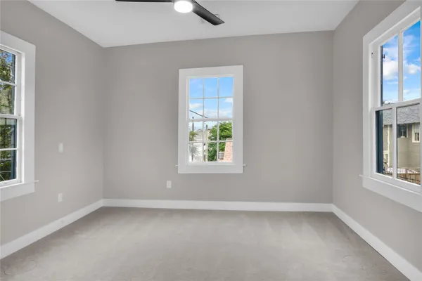 an empty room with windows and closet
