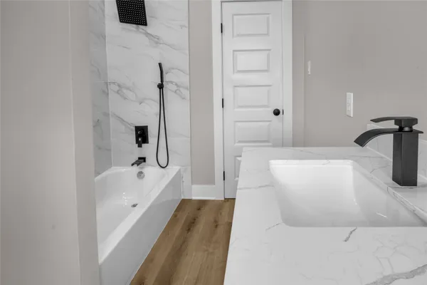 a view of a hallway with wooden floor and stairs