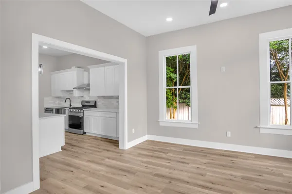 a view of kitchen with wooden floor and electronic appliances