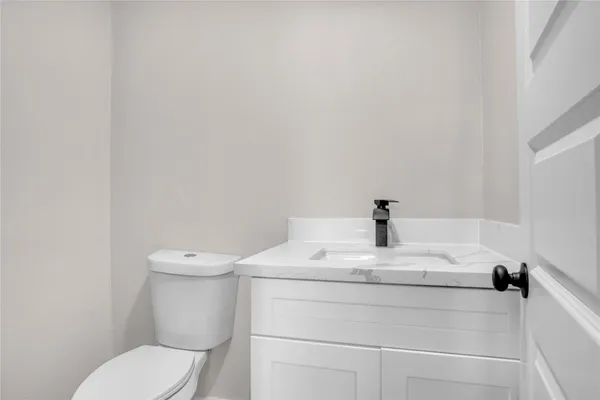a white toilet sitting next to a white sink