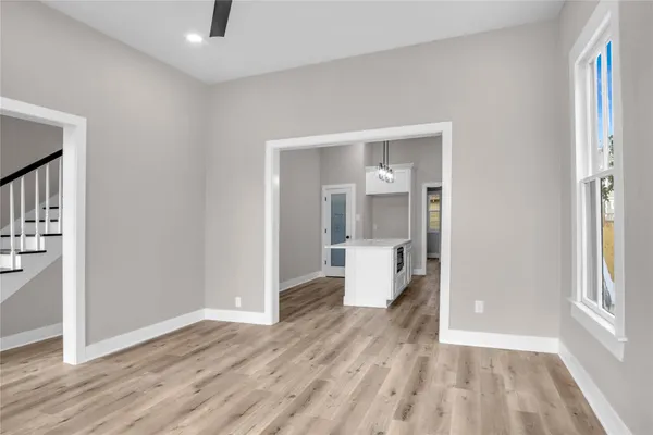 a view of a room with wooden floor and a bathroom