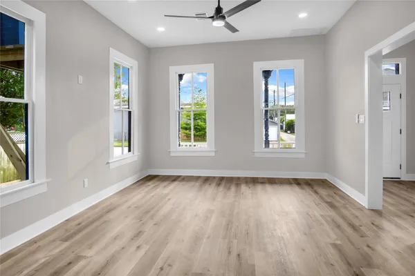 wooden floor in an empty room with a window