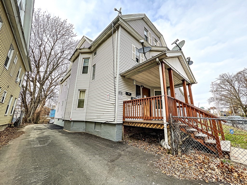 446 Liberty Street Springfield, MA 01104 - Photo 3 of 10 a view of a house with wooden fence
