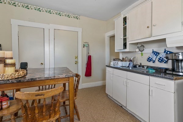446 Liberty Street Springfield, MA 01104 - Photo 8 of 10 a kitchen with stainless steel appliances granite countertop a sink and cabinets
