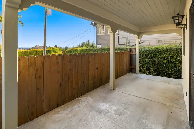 a view of swimming pool of water with lawn chairs and large tree