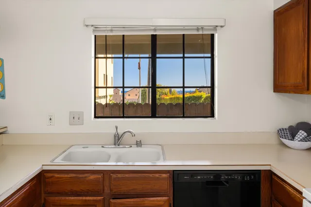 a kitchen with a sink stove top oven and cabinets