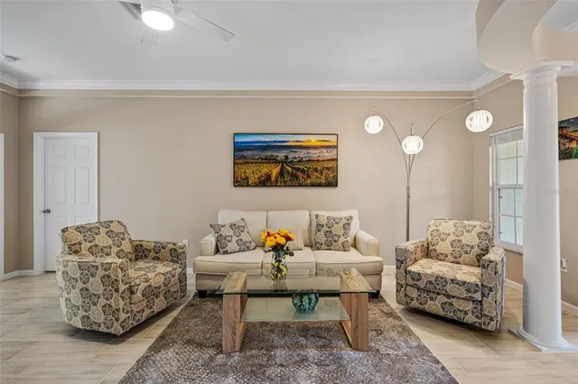 a living room with furniture and a painting on the wall