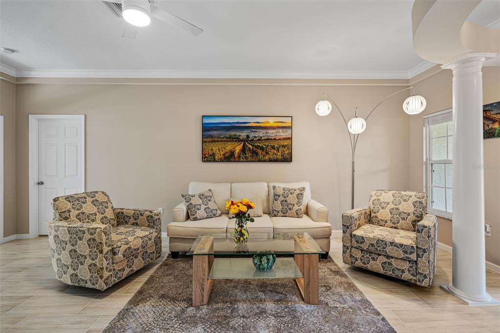 603 Pine Ranch East Road Osprey, FL 34229 - Photo 14 of 37 a living room with furniture and a painting on the wall