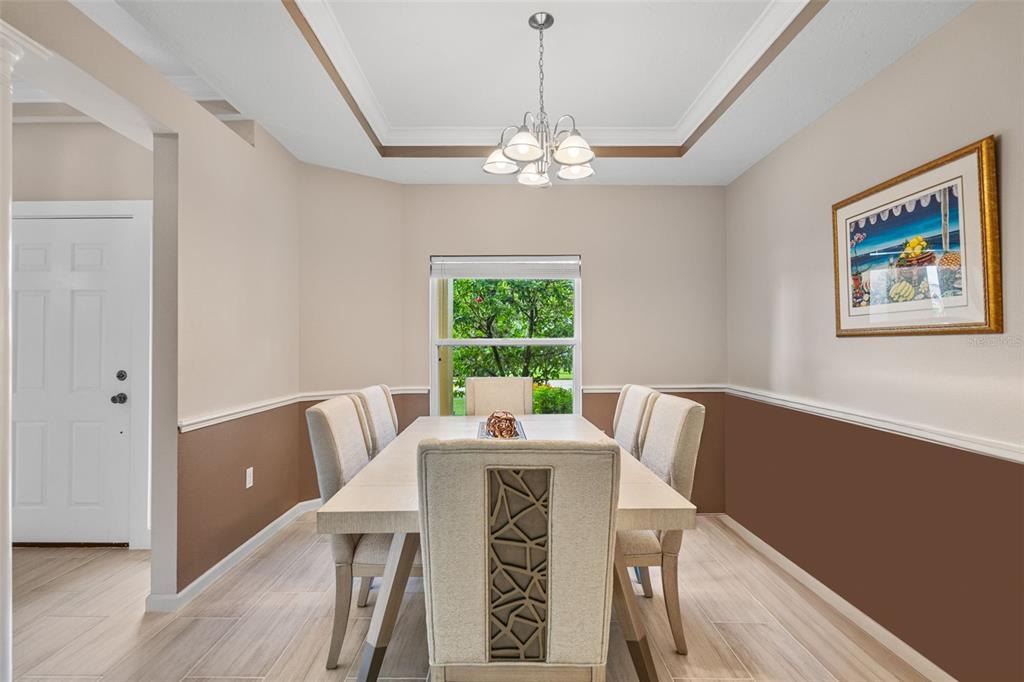 603 Pine Ranch East Road Osprey, FL 34229 - Photo 15 of 37 a view of a dining room with furniture window and wooden floor